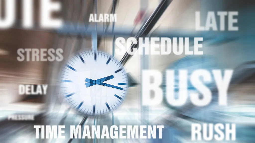 アナログ時計を中心に、「SCHEDULE」や「BUSY」など時間や多忙さを表す英単語が散りばめられたイメージ画像